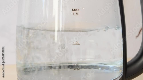 Close up view of boiling water boiling water in a transparent dish 