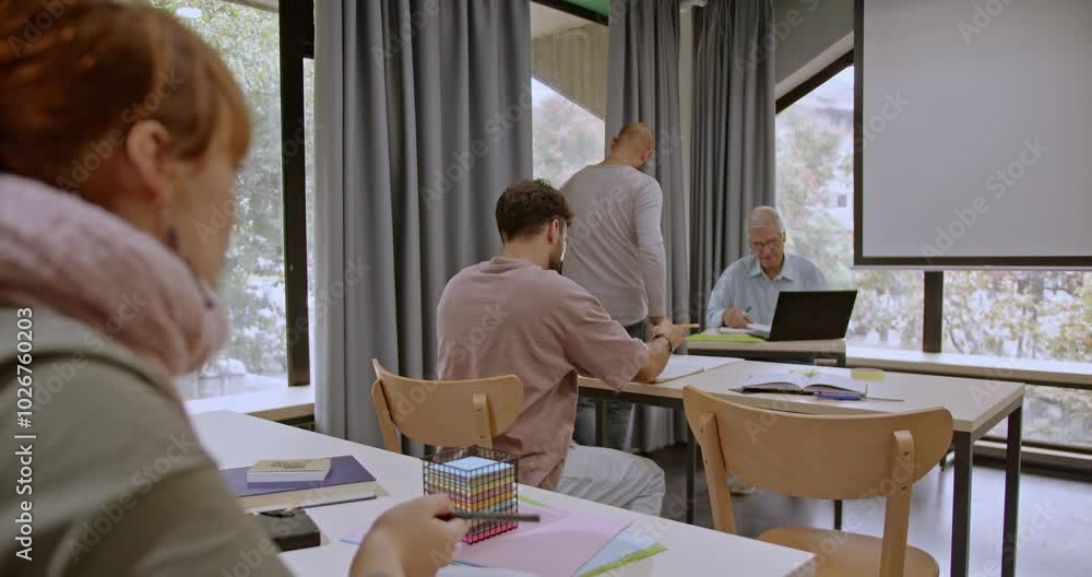 College students gather in a modern library, reviewing class materials, completing homework, and preparing for upcoming exams in a focused, collaborative environment. College students gather in a modern library, reviewing class materials, completing homework, and preparing for upcoming exams in a focused, collaborative environment.