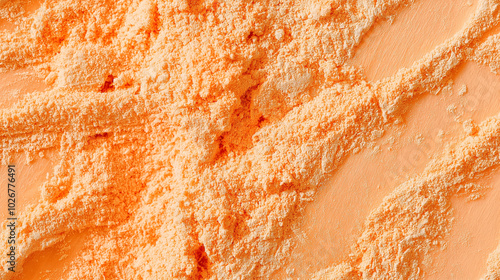 a close-up, top-down view of dried cantaloupe powder, with its soft orange color and fine, powdery texture