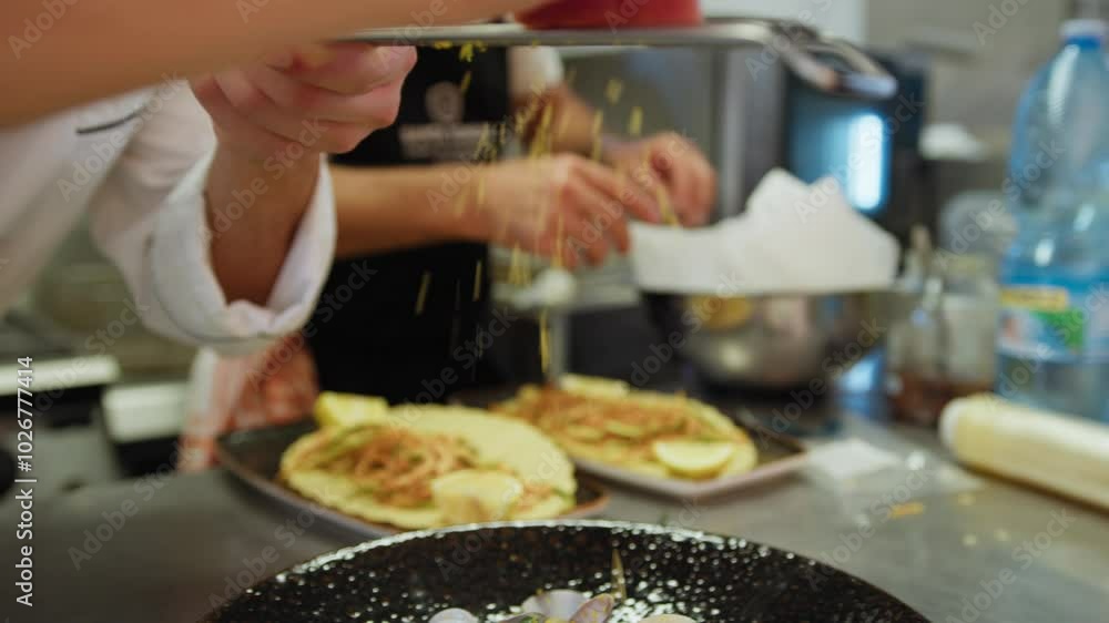Chef is Grating Bottarga into a Plate of Italian Spaghetti with Clams Chef is Grating Bottarga into a Plate of Italian Spaghetti with Clams