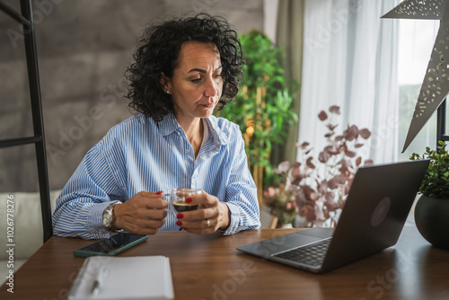 Mature caucasian woman work or learn use laptop at home photo