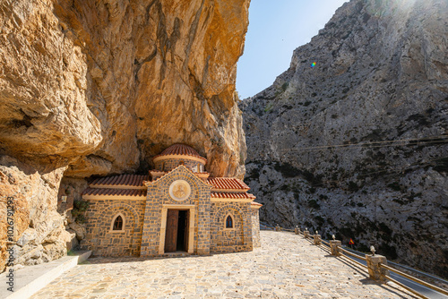 Close-up of huge rock-hewn stone church, Kotsifou valley, clear blue sky, backlit, Saint Nicholas church, Greece, Crete island, wide angle lens
