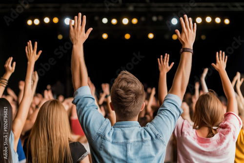 Crowd enjoying a live music concert with raised hands in an evening atmosphere