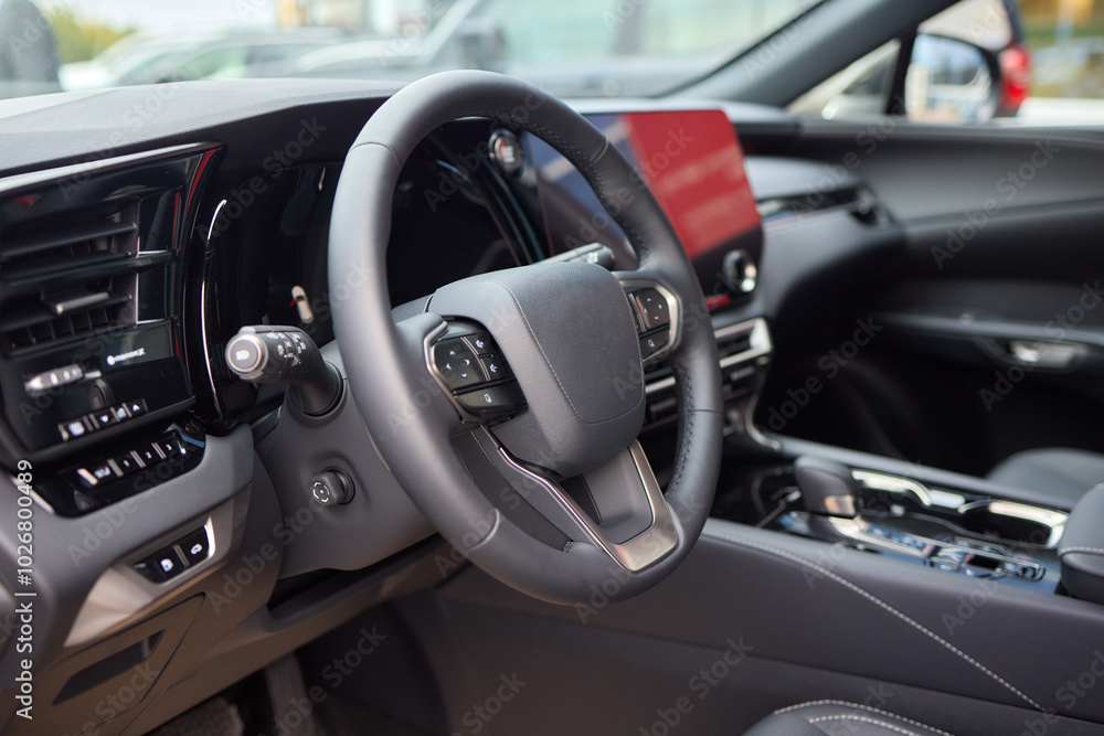 Closeup of a modern car steering wheel with control buttons for technology and convenience Closeup of a modern car steering wheel with control buttons for technology and convenience