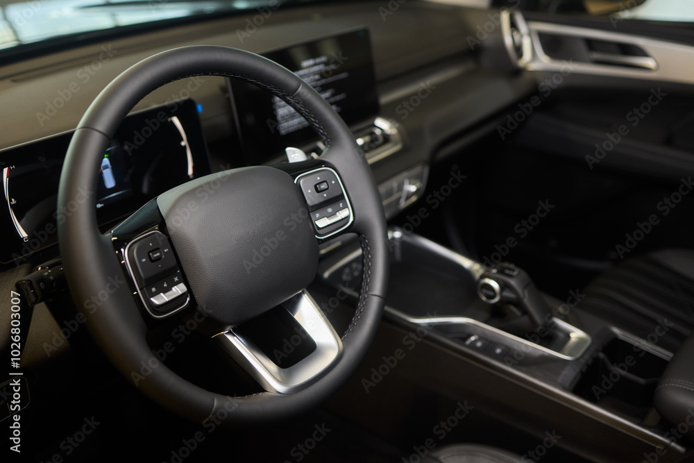 Closeup of a modern car steering wheel with control buttons for technology and convenience Closeup of a modern car steering wheel with control buttons for technology and convenience