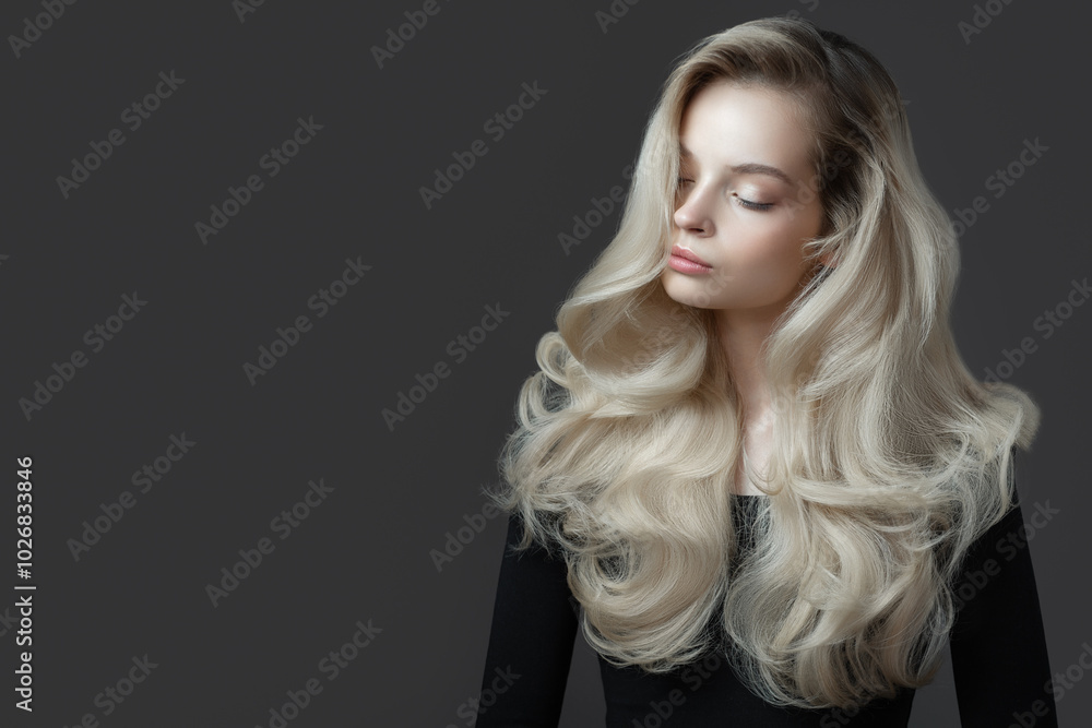 Naklejka premium Beautiful young woman. Gorgeous blonde hair. Gray background.