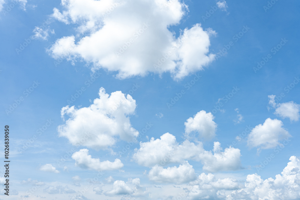 Fluffy white clouds drift across a vibrant blue sky, creating a breathtaking natural canvas Fluffy white clouds drift across a vibrant blue sky, creating a breathtaking natural canvas