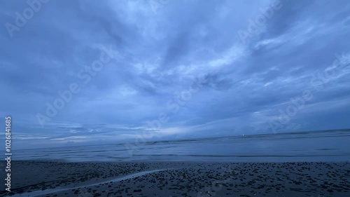 This soothing beach scene captures the calm waves and expansive sky, creating a serene atmosphere. Perfect for those seeking peace and natural beauty by the sea.