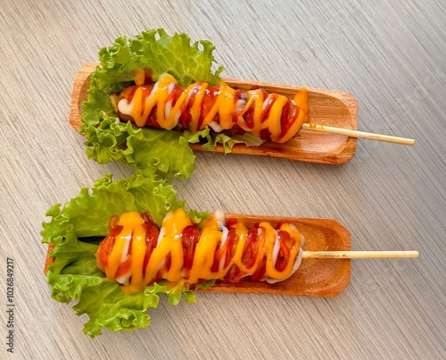 Grilled meat sausages on a wooden plate.