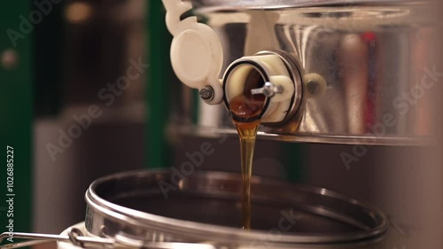 Honey pouring from extractor side angle