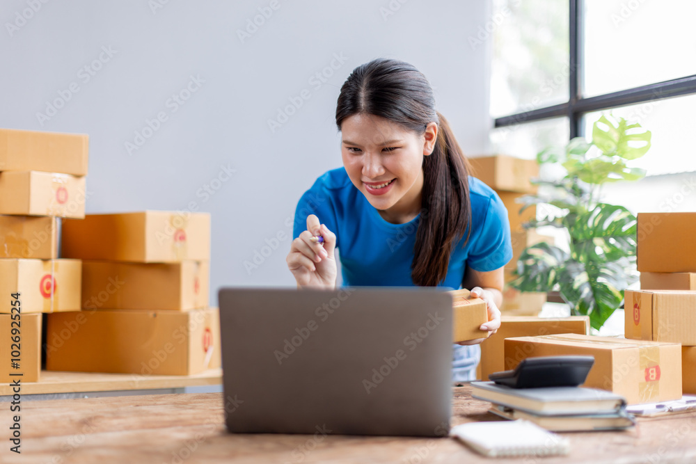 Asian young female sme business owner with product package box at warehouse, merchant seller checking customer address order confirming parcel delivery.
Asian young female sme business owner with product package box at warehouse, merchant seller checking customer address order confirming parcel delivery.