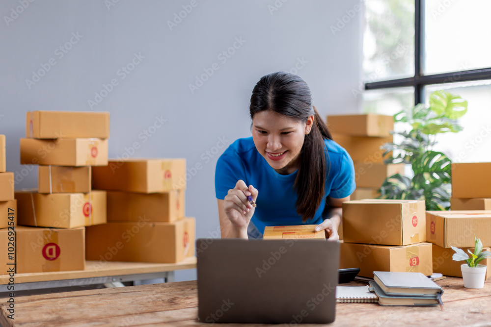 Asian young female sme business owner with product package box at warehouse, merchant seller checking customer address order confirming parcel delivery.
Asian young female sme business owner with product package box at warehouse, merchant seller checking customer address order confirming parcel delivery.