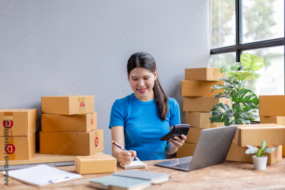 Asian woman entrepreneur using calculator for calculating financial expense at home, Prepare product for packaging process, Sme Online selling, Internet marketing, E-commerce concept.
Asian woman entrepreneur using calculator for calculating financial expense at home, Prepare product for packaging process, Sme Online selling, Internet marketing, E-commerce concept.