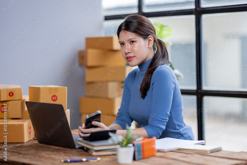 Entrepreneurs small business SME independent asian woman work at home use calculator on phone and laptop for commercial checking. online marketing packing boxes SME sellers concept, sme online sales
Entrepreneurs small business SME independent asian woman work at home use calculator on phone and laptop for commercial checking. online marketing packing boxes SME sellers concept, sme online sales