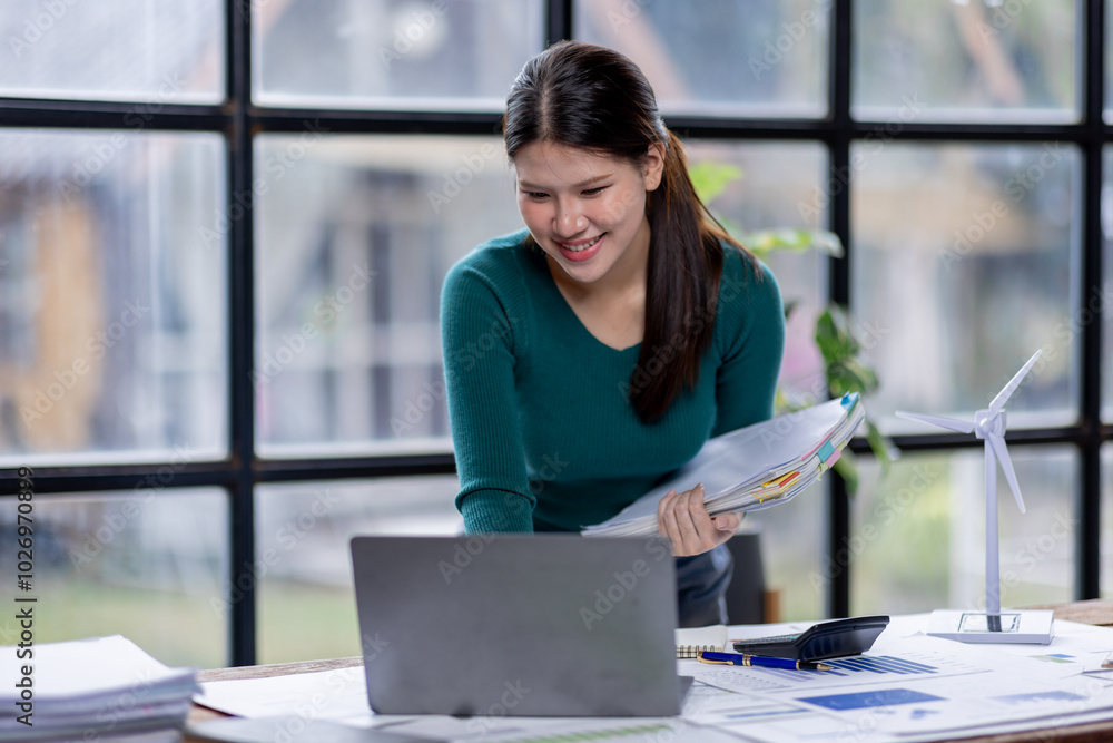 Business woman manager or company worker holding accounting documents laptop, checking financial data or marketing Accountant report working in the office. Business woman manager or company worker holding accounting documents laptop, checking financial data or marketing Accountant report working in the office.