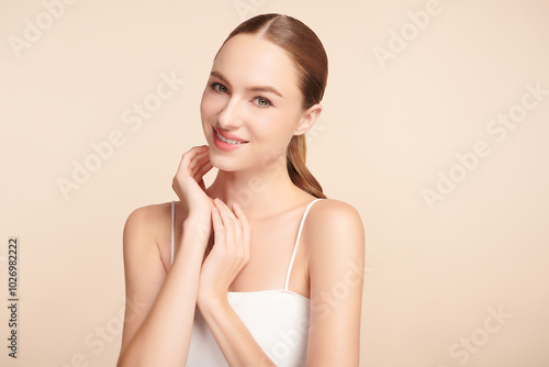 Beautiful young woman with clean fresh skin on beige background, Face care, Facial treatment, Cosmetology, beauty and spa, women portrait.