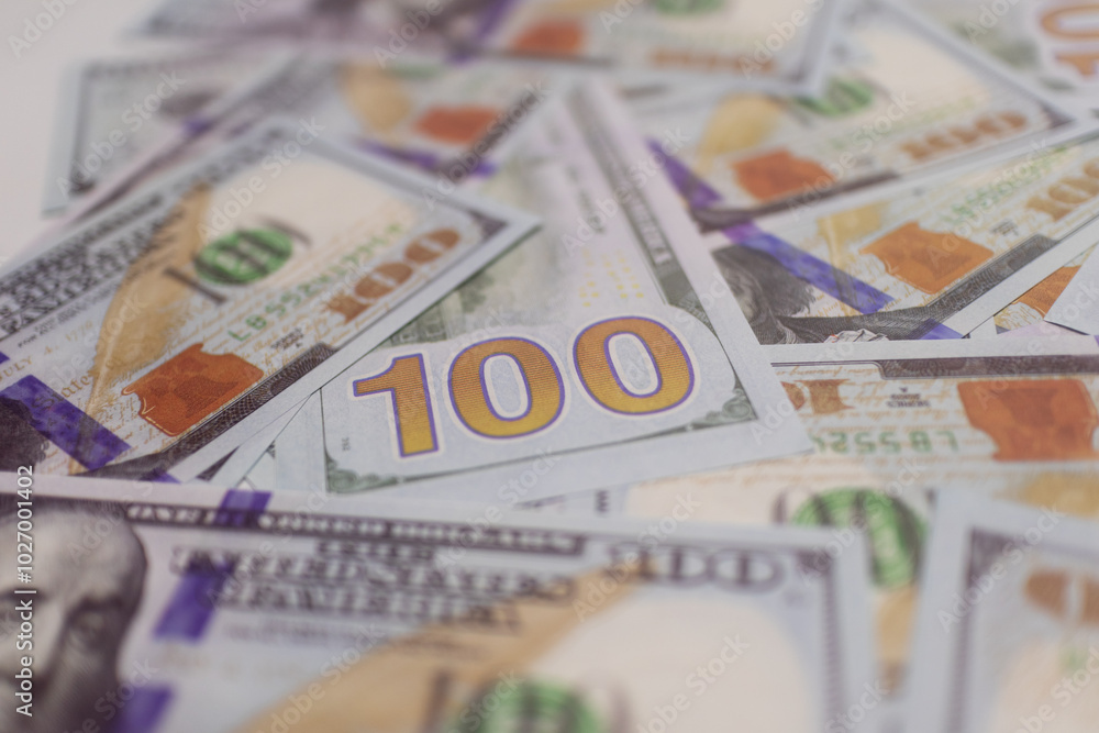 Blue and orange US dollar bills spread out, representing wealth, cash flow, and financial growth in global and domestic markets. Blue and orange US dollar bills spread out, representing wealth, cash flow, and financial growth in global and domestic markets.
