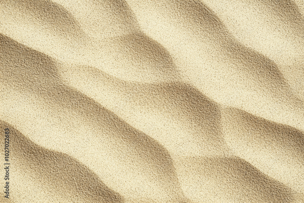 Textured sand patterns created by wind at a coastal area during daylight Textured sand patterns created by wind at a coastal area during daylight