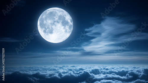 Serene moonlit night sky with clouds and soft light illuminating the landscape