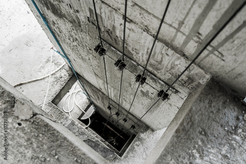 Cables in an elevator shaft at a new building construction site photo