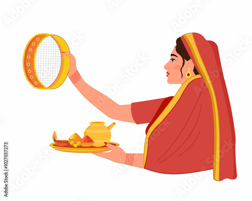 Indian married women performing karwa Chauth puja looking through a sieve and puja thali