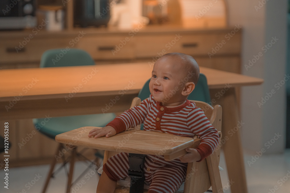 A joyful and happy baby sits in a high chair, enjoying a delightful moment at home A joyful and happy baby sits in a high chair, enjoying a delightful moment at home