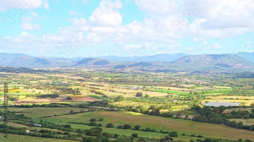 Sirai, Sardinia view from archaeological park of Monte Sirai, Italy with farm farming fields by rolling hills and mountains