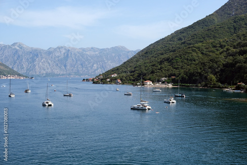 Side view of the Bay of Kotor. View of yachts and liners. Blue sea and mountains