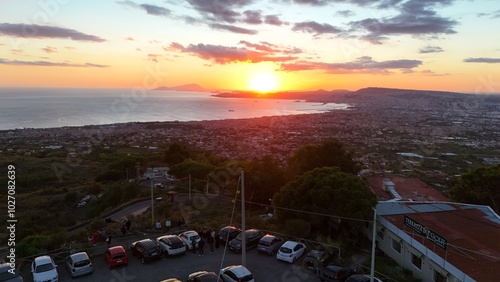 A breathtaking aerial view of Ercolano,with the city nestled between the sea and the mountains.Drone captures the stunning coastal panorama,showcasing the ancient ruins and the shimmering waters below