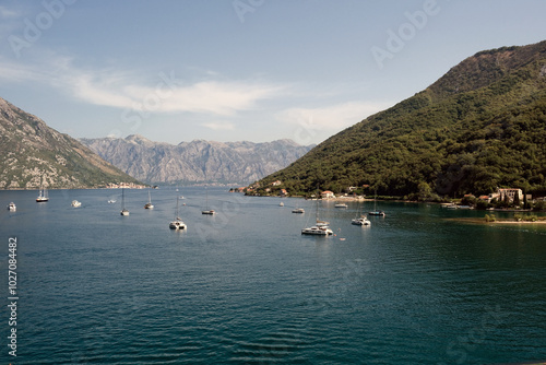 Side view of the Bay of Kotor. View of yachts and liners. Blue sea and mountains