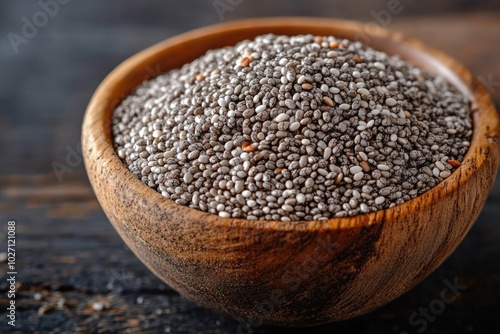 Chia seeds piled high in wooden bowl on rustic table