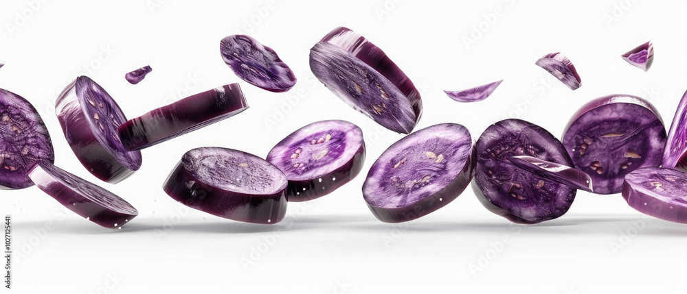 Thin round Eggplant Vegetables slices flying in the air isolated on white background Thin round Eggplant Vegetables slices flying in the air isolated on white background