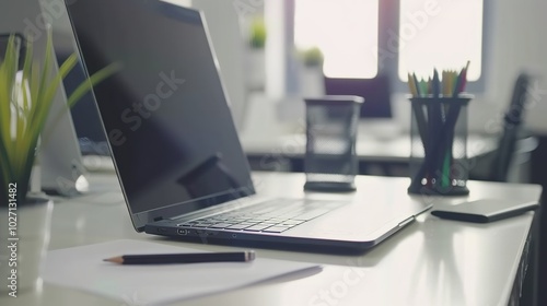 Wallpaper Mural Front view laptop on white table. There is paper and a pen holder nearby. In modern office space Torontodigital.ca