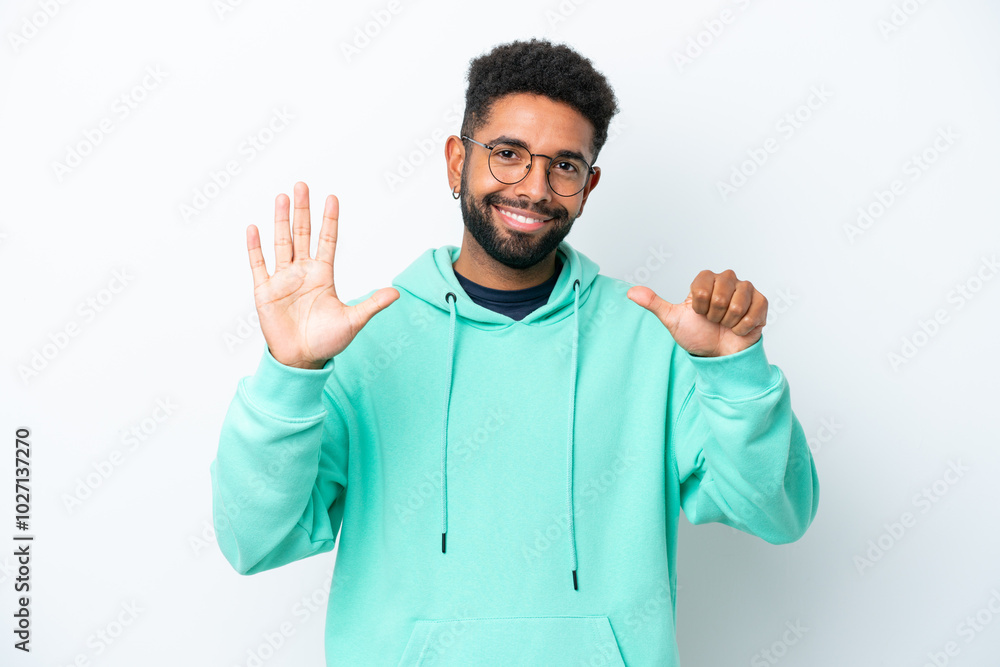 Young Brazilian man isolated on white background counting six with fingers Young Brazilian man isolated on white background counting six with fingers