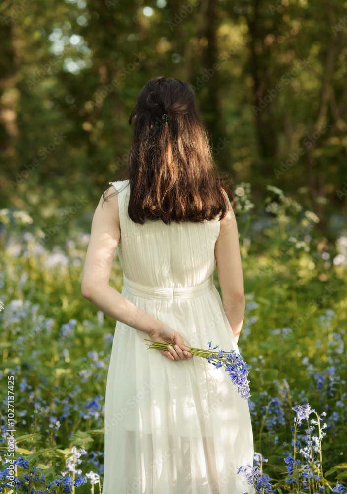 Woamn Holding Bluebells Behind Her Back Woamn Holding Bluebells Behind Her Back