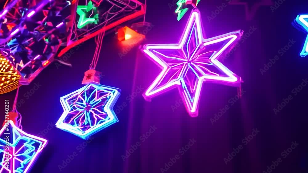 Neon stars and geometric shapes light up a dark room. Neon stars and geometric shapes light up a dark room.
