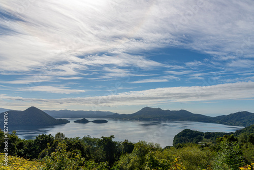 Lake Toya is a volcanic lake in Hokkaido, Japan, known for its tranquil waters and the surrounding natural beauty