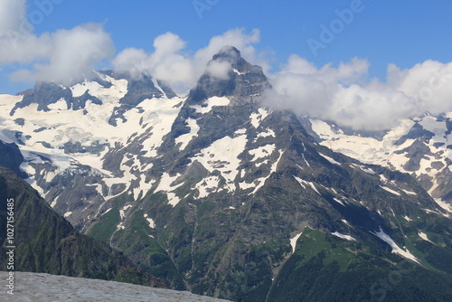 mountain peaks of elbrus region in dombai in midsummer photo