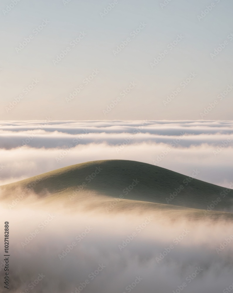 Obraz premium A whimsical hill under a blanket of clouds in the morning.