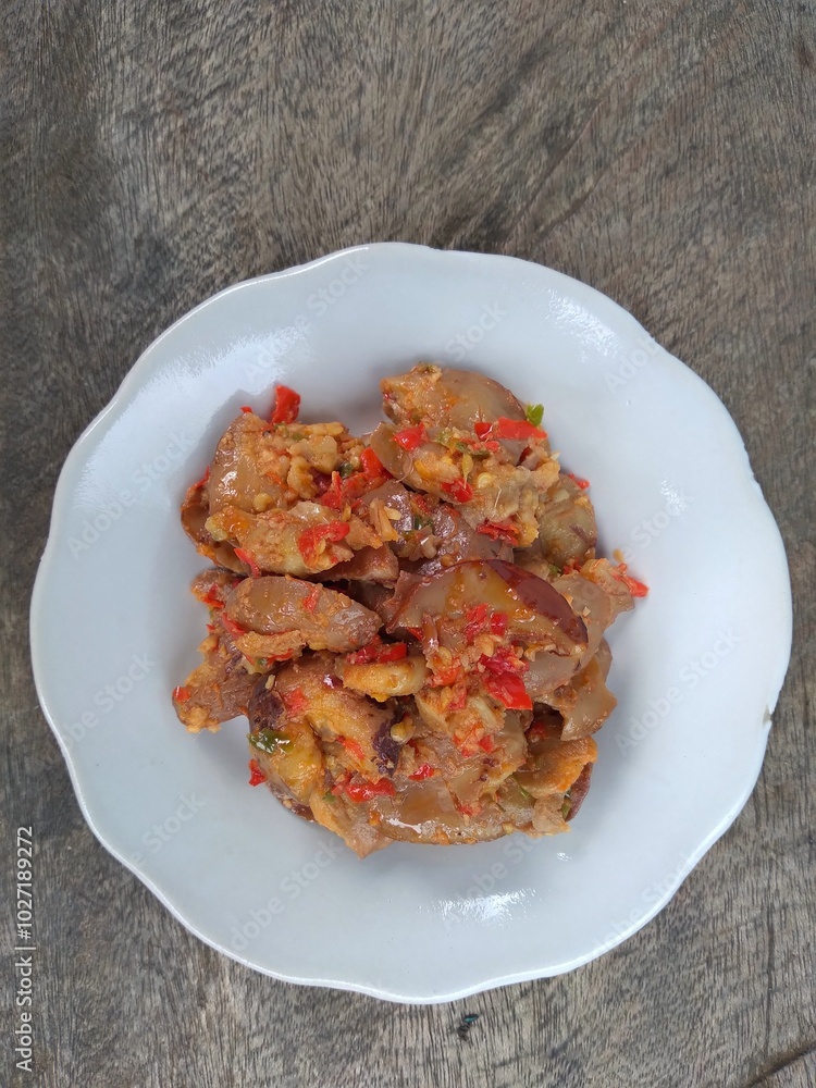 Jengkol balado is a traditional indonesian food. Made from jengkol seeds or dogfruit cooked with balado or spicy chili sauce. Other name is sambal jengkol.