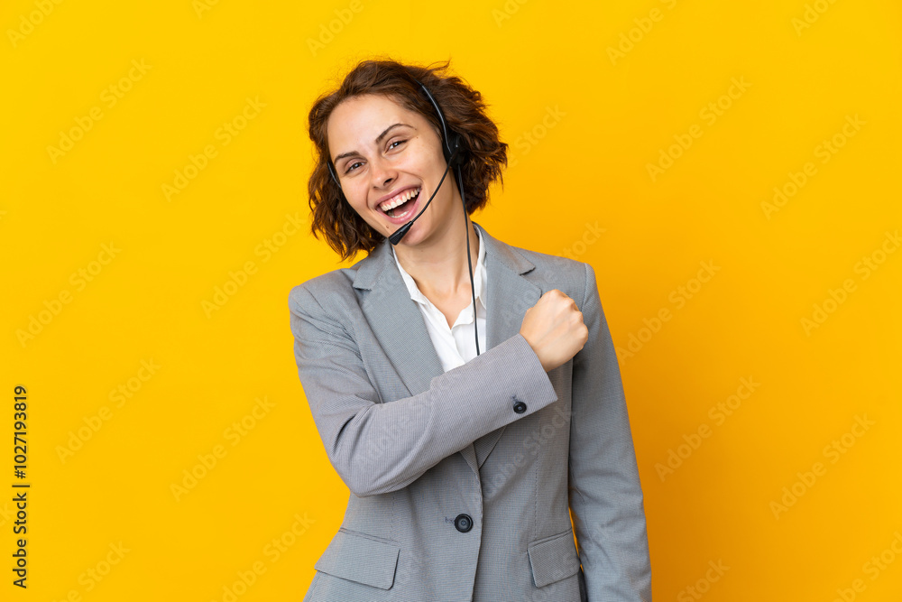 Young English woman isolated on yellow background celebrating a victory