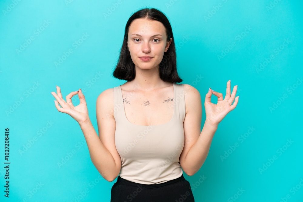 Young caucasian woman isolated on blue background in zen pose Young caucasian woman isolated on blue background in zen pose
