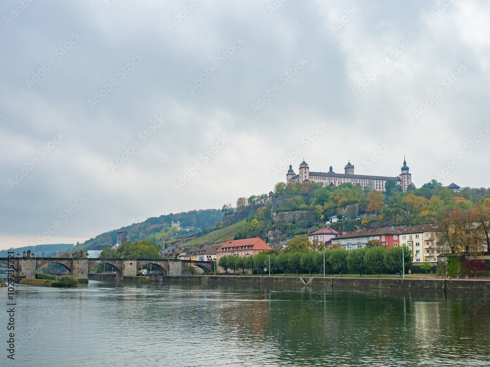Wuerzburg, Germany - Oktober 19th 2023: View over the Main river towards the historic bridge and the bastion. Wuerzburg, Germany - Oktober 19th 2023: View over the Main river towards the historic bridge and the bastion.