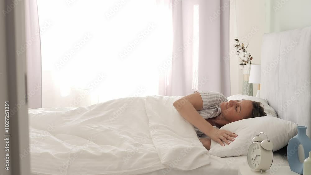 Morning scene of woman waking up and stretching on bed. Gentle stretch to start day, showcasing natural potyagivanie. Perfect video for themes of relaxation, morning routines, and daily potyagivanie. Morning scene of woman waking up and stretching on bed. Gentle stretch to start day, showcasing natural potyagivanie. Perfect video for themes of relaxation, morning routines, and daily potyagivanie.