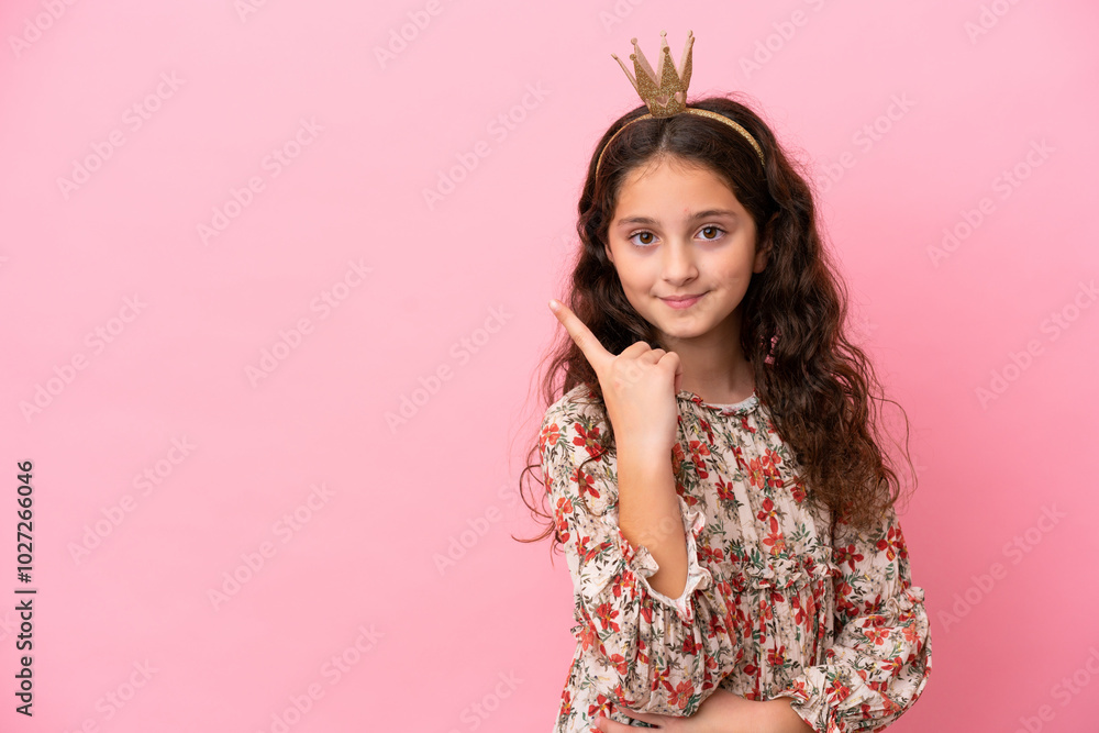 Little caucasian princess with crown isolated on pink background with shocked facial expression Little caucasian princess with crown isolated on pink background with shocked facial expression