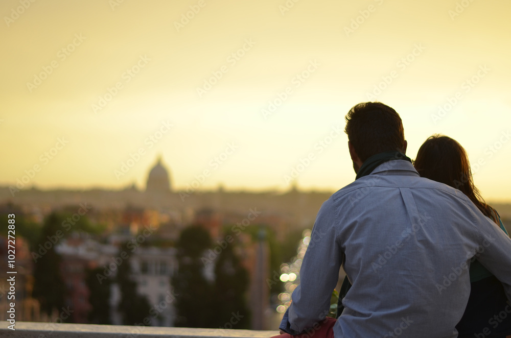 Сouple admiring the view of the city at sunset. Romе, Italy Сouple admiring the view of the city at sunset. Romе, Italy