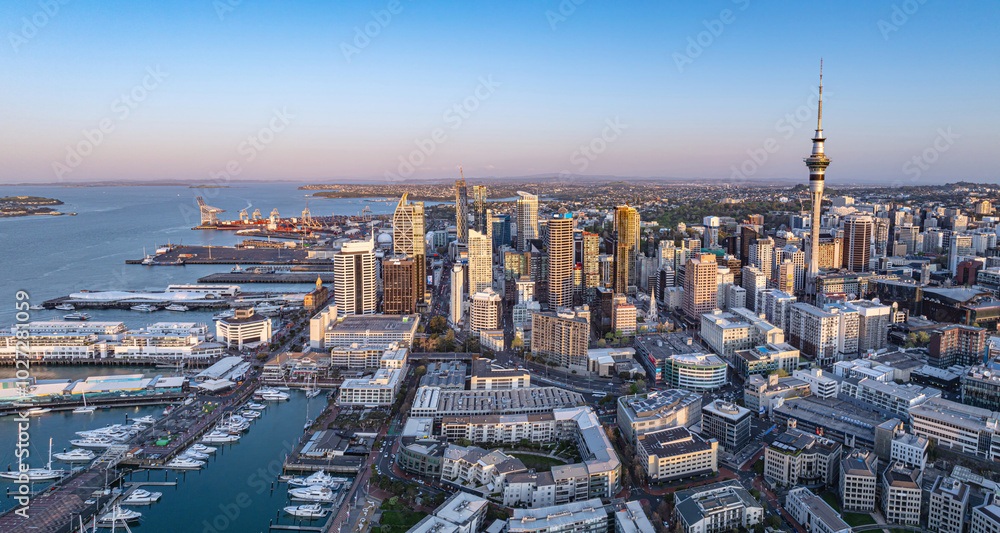 Fototapeta premium Aerial: Panoramic view of Auckland city skyline at sunset, New Zealand