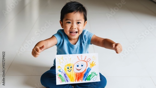 A young boy proudly displaying his colorful drawing of happy characters indoors in a bright environment