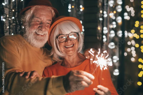 Photography Cheerful caucasian senior couple holding sparklers celebrating new year