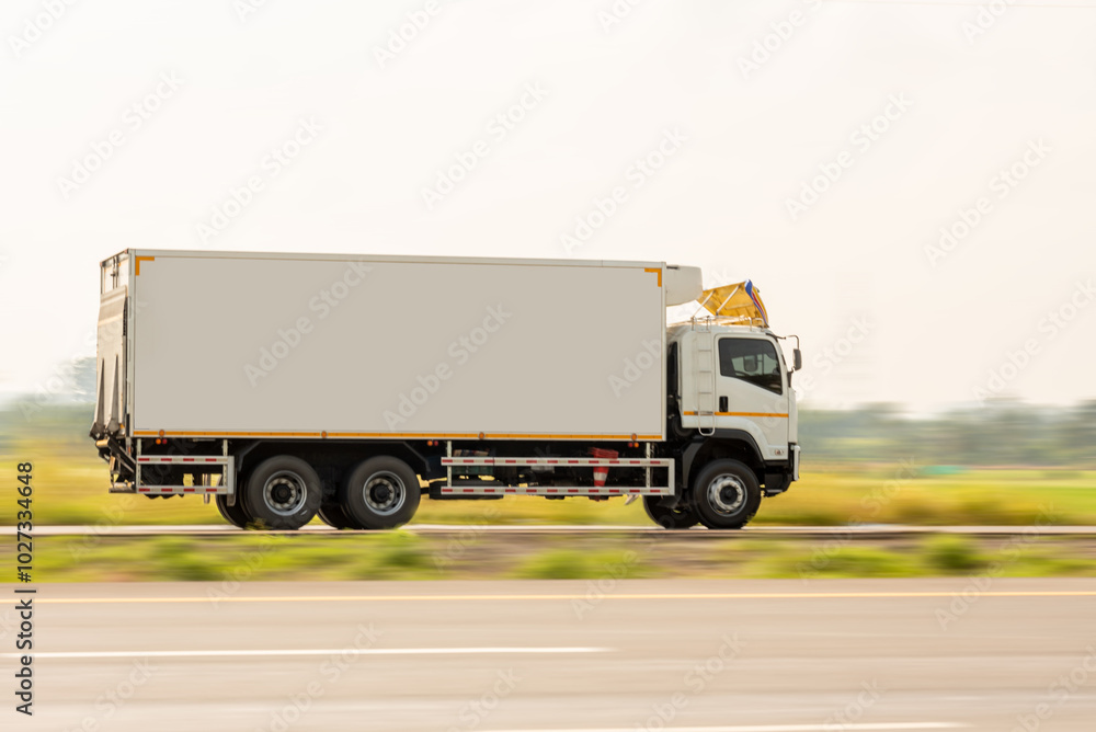 Side view of a small truck driving on a country road, truck running on the road, small truck on the road. Side view of a small truck driving on a country road, truck running on the road, small truck on the road.